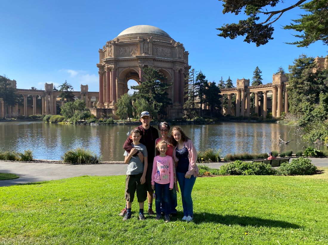 Family posing together on a bright sunny day during a San Francisco tour with Spark Experiences