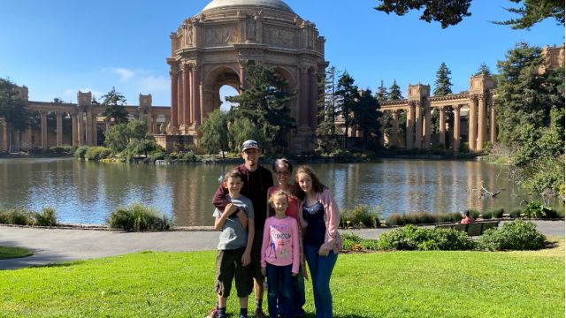 Family posing together on a bright sunny day during a San Francisco tour with Spark Experiences